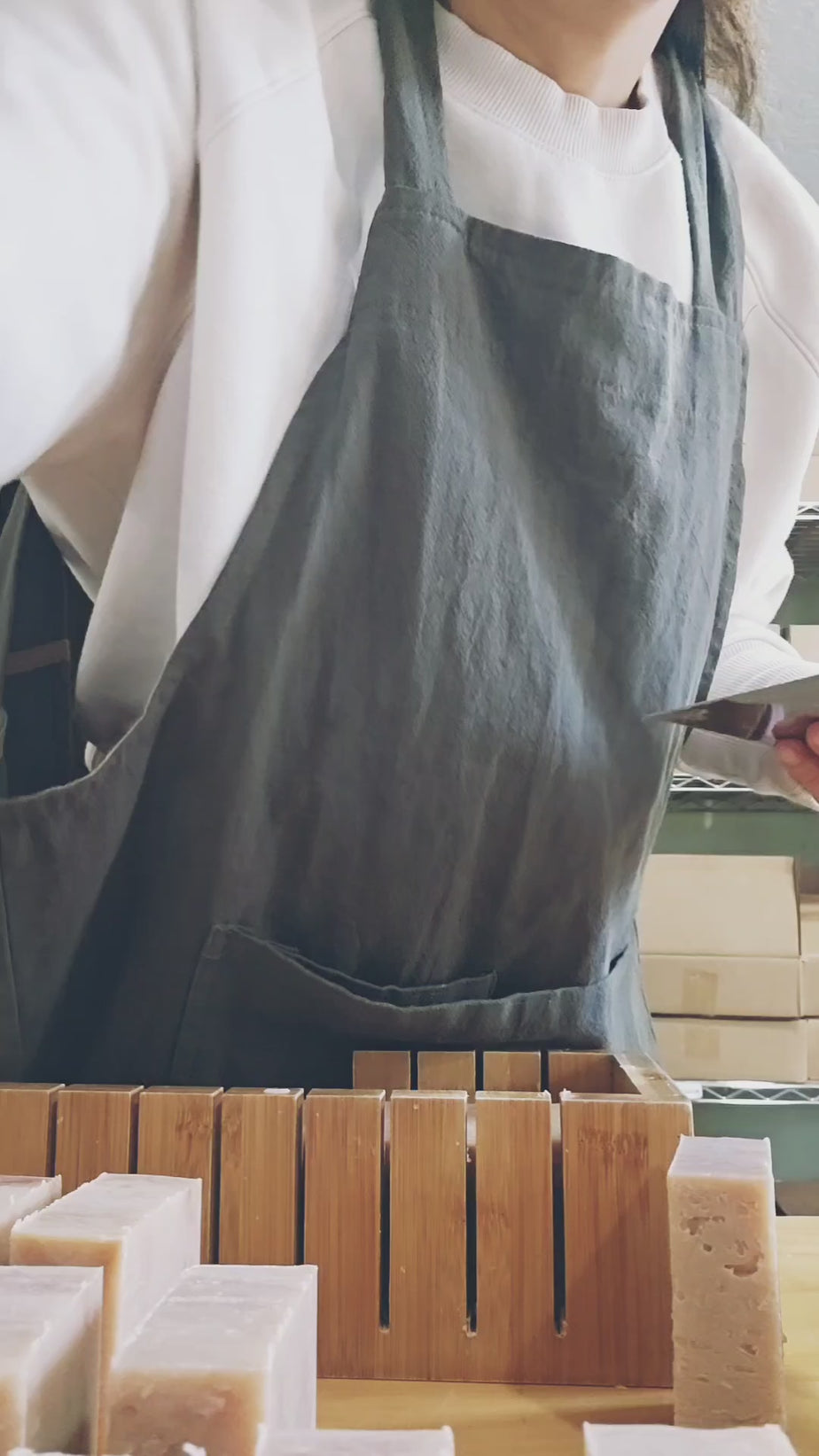 Komoni founder/owner doing the final hand cutting of some Face & Body Cleanser Bar soaps.  